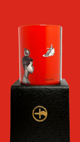 Red scented candle with 'The Opera is Burning' text and proprietary Créateur Olfactif illustrations on a red background