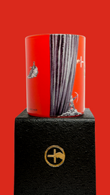 Red scented candle with 'The Opera is Burning' text and proprietary Créateur Olfactif illustrations on a red background