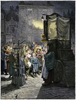 A street puppet theatre at night